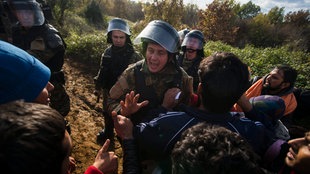 Polzisten schlagen auf Flüchtlinge ein