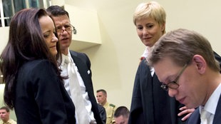 Die Angeklagte Beate Zschäpe (l-r) steht zum Prozessauftakt am 06.05.2013 im Gerichtssaal in München (Bayern) und unterhält sich mit ihren Anwälten Wolfgang Stahl, Anja Sturm und Wolfgang Heer